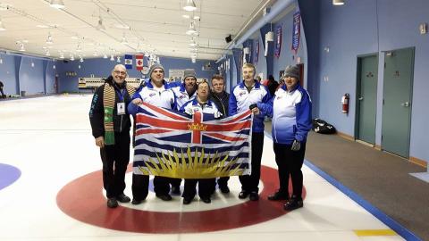 SOBC - Quesnel curling team holding up B.C. flag in group photo