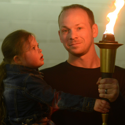 Mike and Kelsey hold the Flame of Hope at the 2018 Bowling Championships.